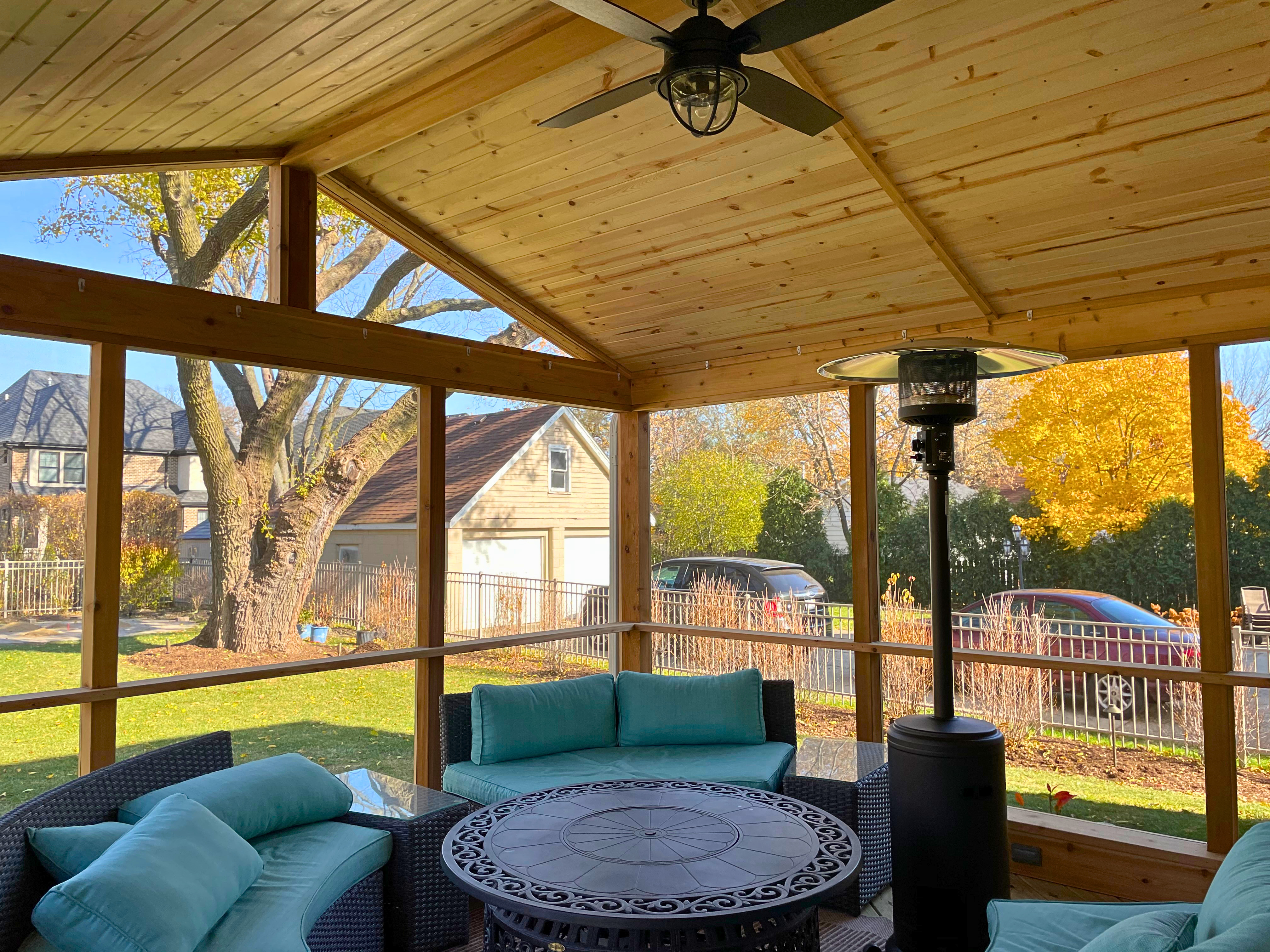 Custom porch in Buffalo Grove with cozy outdoor furniture and an outdoor heater.